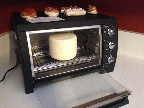 Setting it in the open, COLD toaster oven for an hour gives the surface a chance to dry a bit before waxing it.