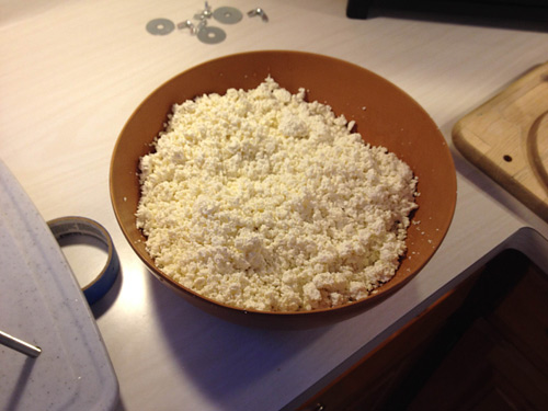 A large, flat bowl makes an excellent container for hand mixing the salt into the curds.